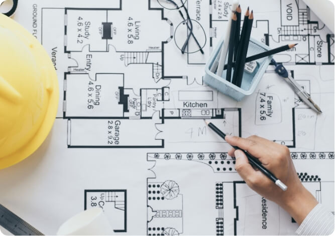 architectural drawings for a family home with a a hard hat from a construction business