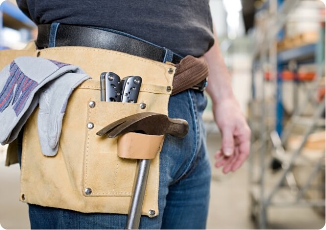 Construction worker with tool belt finding materials to use for the job