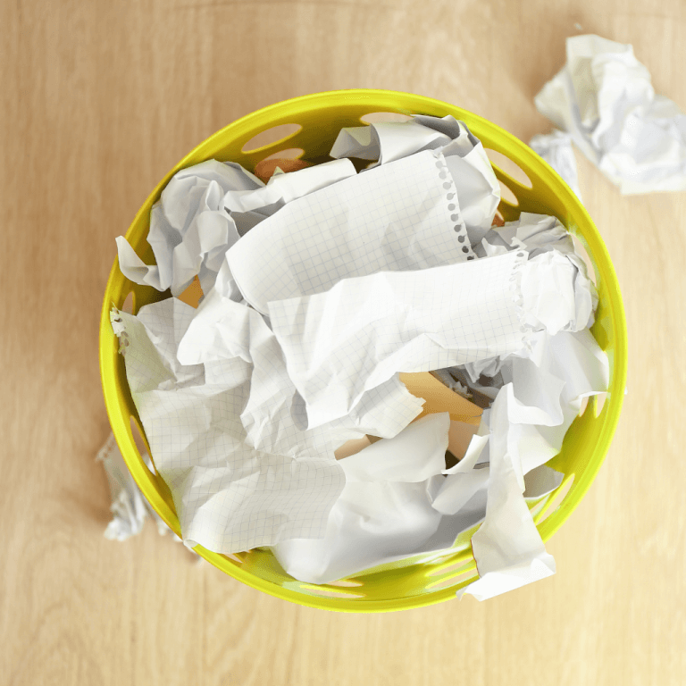 Paper Bin full with paper and a expense receipt lost