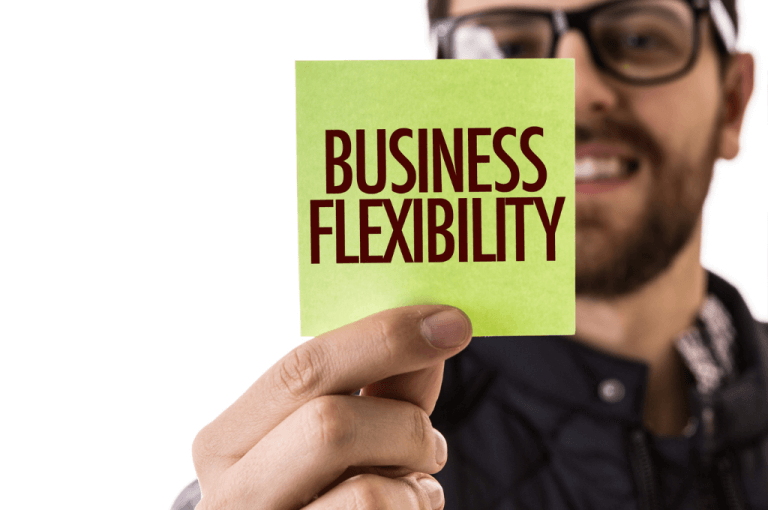 person showing a post it note with business flexibility for growth or reduction in business employees