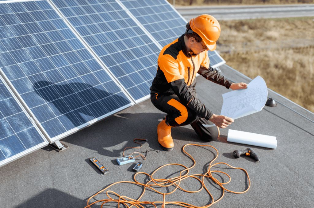 Electrician installing Solar panels on a house